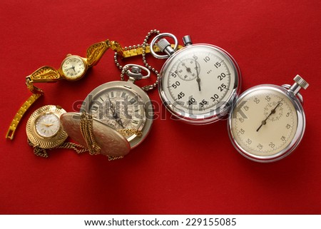 Pocket vintage watch and stopwatch on red