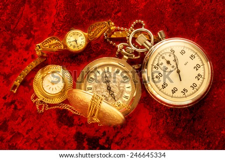 Pocket vintage watch and stopwatch on red