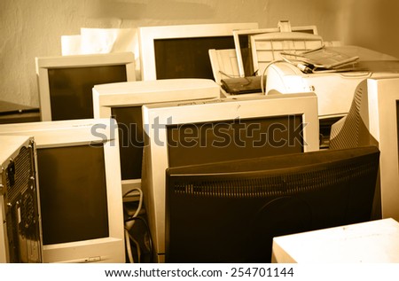 Old computer monitors gathered on the floor