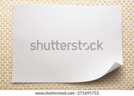 Blank sheet of paper on white fabric background