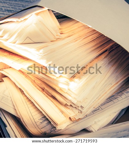 Dirty messy paper documents as background closeup