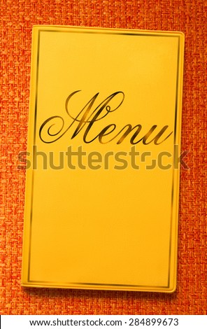The yellow framed menu book in closeup