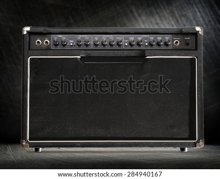 Guitar amplifier on black steel scratchy background