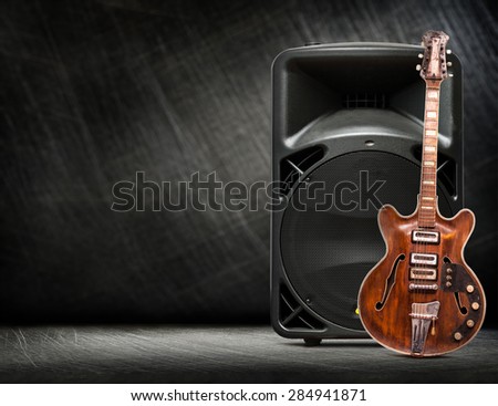 Old electric guitar vertical on steel scratchy background