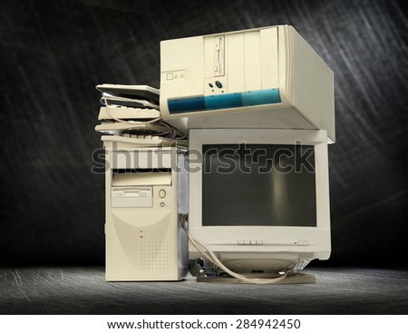 Heap of used computers and monitors on steel background