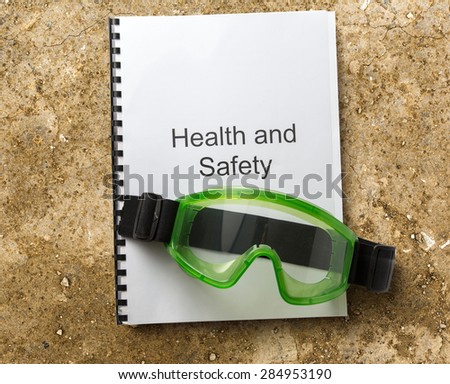 Health and safety register with goggles in closeup