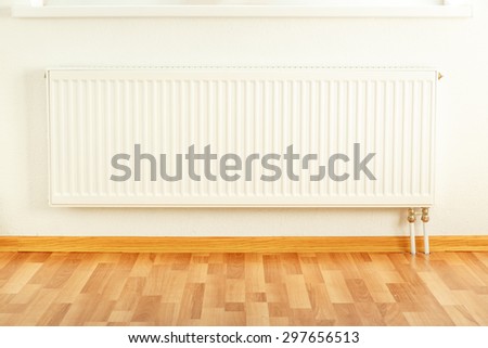White radiator in the apartment framed with floor