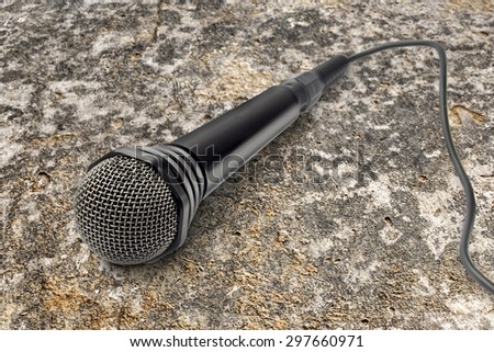 Black microphone on the stone background closeup