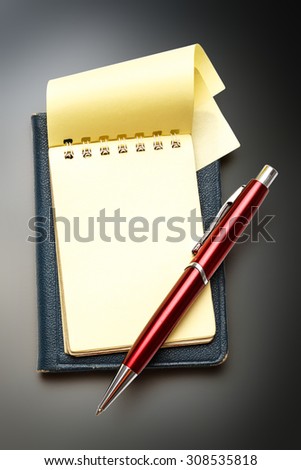 Yellow blank notepad open with red pen