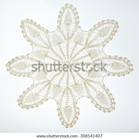 Crocheted lace napkin as home decoration on white