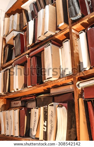 Paper documents stacked in archive on shelf