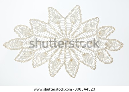 Crocheted lace napkin as home decoration on white