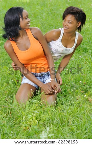 Two African girls having fun in grass area