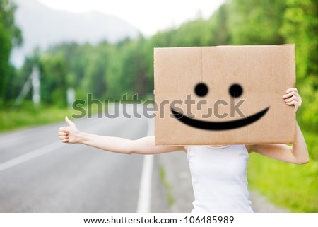 the girl waiting the car with cardboard