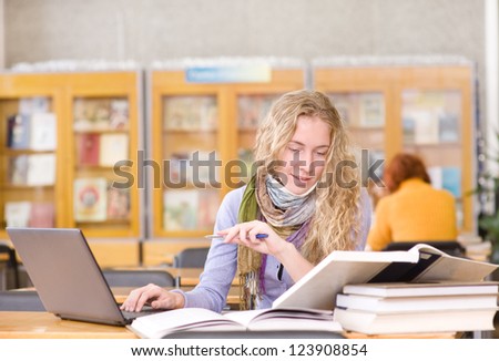 focused student using computer in a library