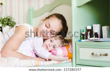 mother and sick daughter sleep together