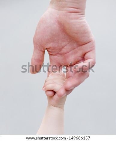 Child holding father's hand