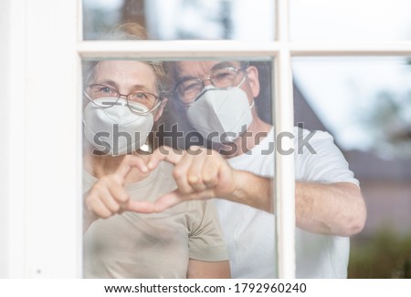 Similar – Image, Stock Photo Senior couple wearing protective face masks outdoors