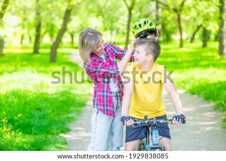 Similar – Image, Stock Photo Mother putting bicycle helmet on her son