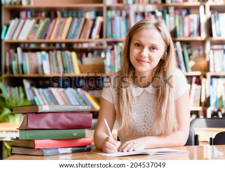 Portrait of a student girl studying at library