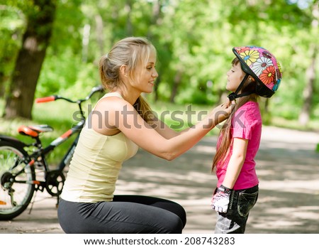 Similar – Image, Stock Photo Mother putting bicycle helmet on her son