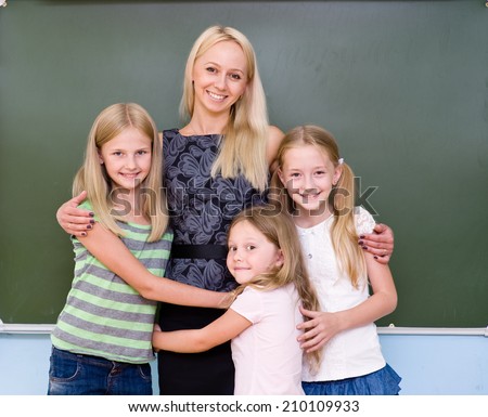 Children hugging their teacher