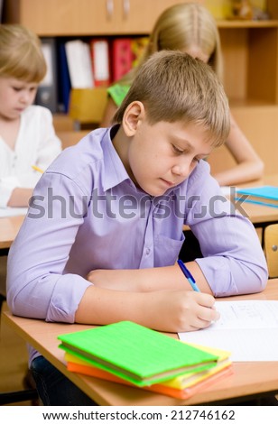 Portrait of student writing exam