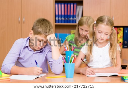 Group of elementary school pupils takes the test in class