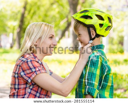 Image, Stock Photo Mother putting bicycle helmet on her son