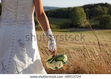 lovely bride holding a bouquet of flowers in natural lighting