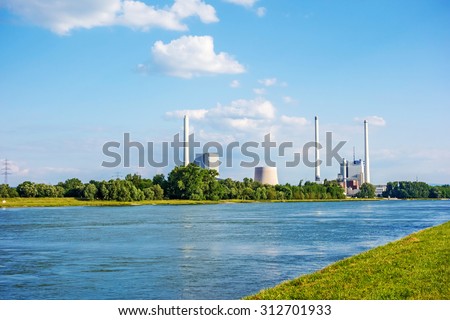 Karlsruhe, Germany - May 31, 2014: Steam power plant and hard coal-fired power station Rheinhafen-Dampfkraftwerk Karlsruhe EnBW, river Rhine in foreground.
