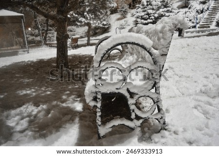 Image, Stock Photo Footpath in winter, always straight ahead, on the left of it a wooden fence, behind it bushes, on the right side of the path a brook bank. Falling snowflakes, in the distance trees can be seen in the mist.