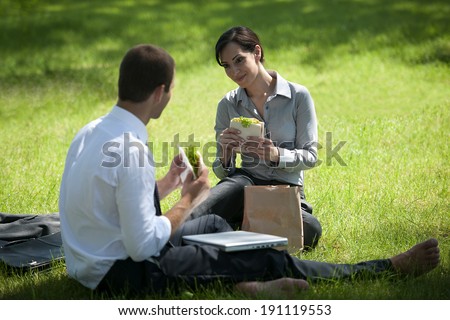 Colleagues having lunch break outdoors