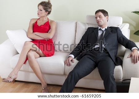 Tired man on sofa, disappointed woman ready to go out
