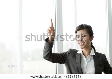 Chinese Businesswoman Pointing at Copy-space