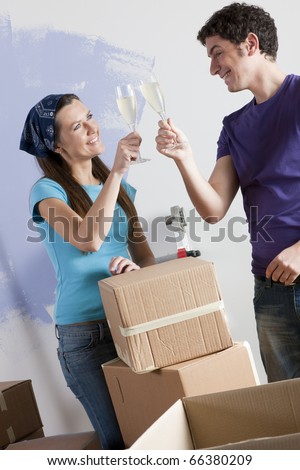 Young couple celebrating their new house on moving day