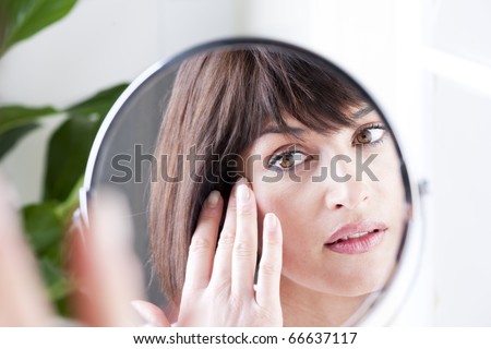 Woman Looking At Herself In The Mirror