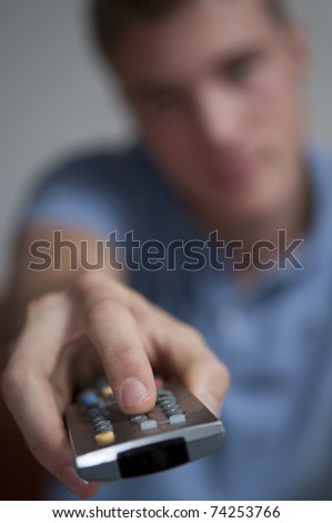 Teenage Boy with TV remote control