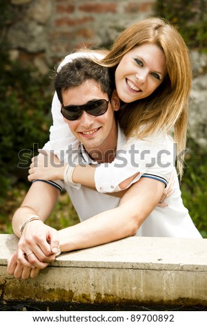 Young couple doing window shopping in love embracing