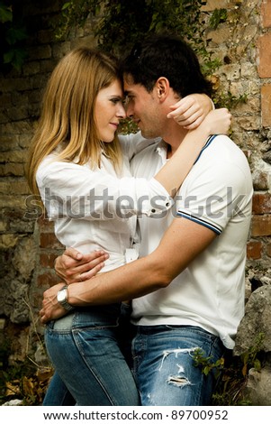 Young couple doing window shopping in love embracing