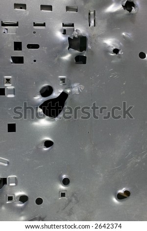 Computer tower with bullet holes. Virus? Nice pattern/background for high tech.