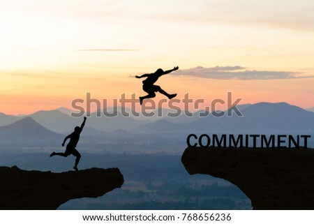 Men jump over silhouette failure commitment to success 商業照片 © 