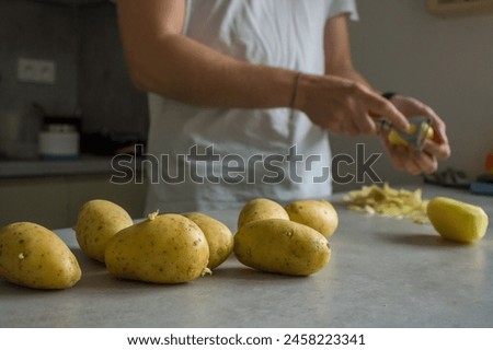 Similar – Image, Stock Photo Unrecognizable chef peeling potato in kitchen