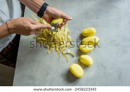 Similar – Image, Stock Photo Unrecognizable chef peeling potato in kitchen