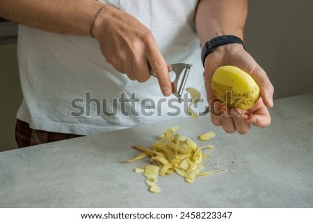 Similar – Image, Stock Photo Unrecognizable chef peeling potato in kitchen