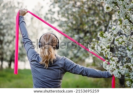 Similar – Image, Stock Photo Woman with resistance band on wrists working out at home