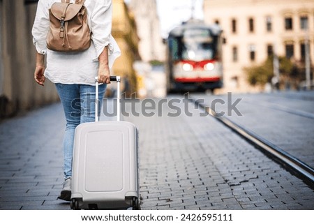 Similar – Image, Stock Photo Traveling woman with suitcase in airport