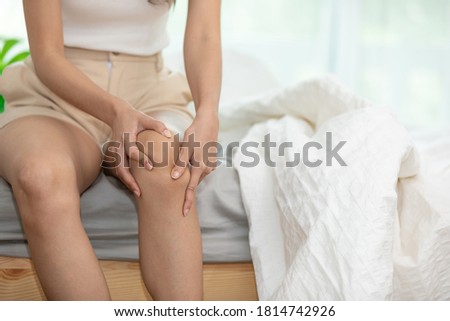 woman have a kneecap pain sitting on bed in bedroom after wake up feeling so illness,Healthcare concept Сток-фото © 