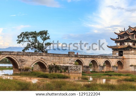 Ancient bridge in south China with cloudscape