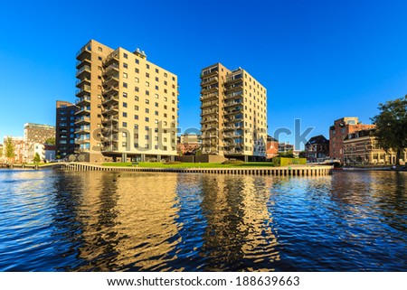 Apartments in a city in evening glow seen from water